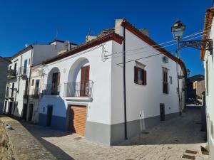 a white building on the side of a street at AL BELVEDERE in Acerenza