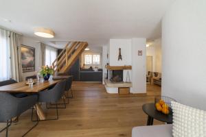 a dining room and living room with a table and chairs at Gamsalpblick in Wildhaus