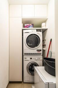 a washer and a washing machine in a kitchen at Beautiful apartment in the city and free parking in Luxembourg