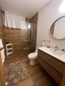 a bathroom with a sink and a toilet and a mirror at sunrise-villa-at-vistacana in Punta Cana