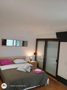 a bedroom with two beds and two windows at Hostel Lega House in Osijek