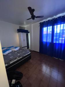 een slaapkamer met een bed en een plafondventilator bij Apartamento 106 in Cabo Frio