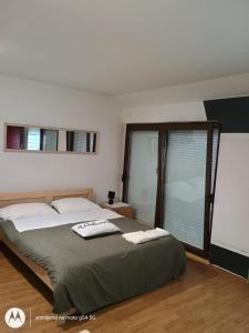 a bedroom with a bed with two towels on it at Hostel Lega House in Osijek
