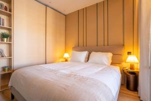 a bedroom with a large white bed with two lamps at Riverside Oasis by LovelyStay in Vila Nova de Gaia