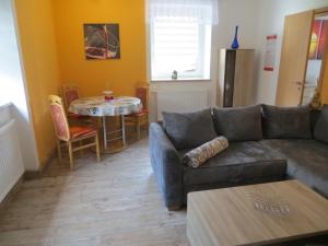 a living room with a couch and a table at Ferienwohnung Beck Schneeberg in Schneeberg