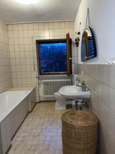 a bathroom with a tub and a toilet and a sink at Haus Burga in Prackenbach