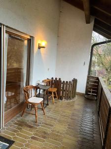 a dining room with tables and chairs and a window at Haus Burga in Prackenbach