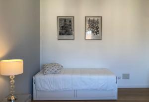 a bedroom with two pictures on the wall and a bed at Bilocale moderno - Lorenteggio 145 in Milan