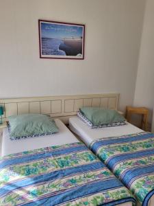 two beds sitting next to each other in a room at Résidence Rose des Vents in Jullouville-les-Pins