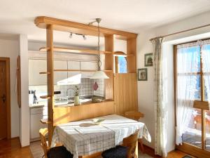 a dining room with a table and a kitchen at Dammerer Hof inkl. Chiemgaukarte in Ruhpolding