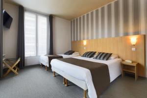 a hotel room with two beds and a window at Hotel Paris Villette in Paris