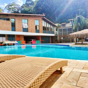 a large swimming pool in front of a building at EcoHotel Vale do Sol in Embu