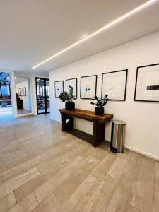 a room with a table and pictures on the wall at Avellino 3BR Zona 10 Luxury Suite - Pool, Gym & View in Guatemala +32 photos