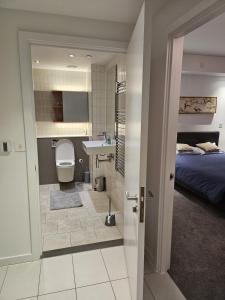 a bathroom with a bed and a toilet and a sink at off 13 in London