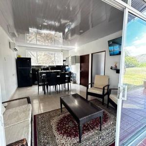 a living room with a table and a dining room at Ecofinca San José in Carmen de Apicalá +30 photos