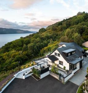 an aerial view of a house with a view of the water at Fern View House over Loch Ness in Inverness