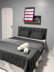 a black and white bed with a stuffed animal on it at Confortável APTO em Boa Vista. in Boa Vista