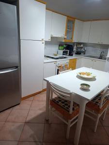 a kitchen with a white table with a plate of food on it at Il Melograno in Gaggi