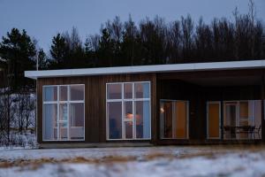 a small house with a large glass door at Golden Circle Villa - Hot Tub & Sauna in Fludir