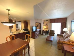 a living room with a couch and a dining room at Quality Inn West Lafayette - University Area in Lafayette