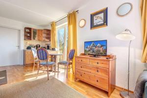 een woonkamer met een tafel en stoelen en een dressoir bij Dia Mare, EG Ost in Ueckeritz