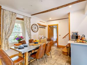 a kitchen and dining room with a table and chairs at 3 Bed in Settle 76650 in Stainforth