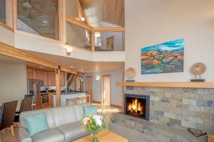 a living room with a couch and a fireplace at Surfside on Lake Superior in Tofte