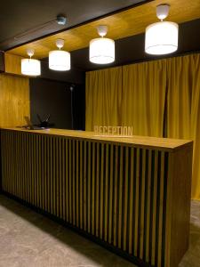 a reception desk in a room with a yellow curtain at Atlas Hotel in Almaty