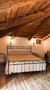 1 dormitorio con 1 cama en una habitación con techos de madera en La busa camere e trattoria, en Ponte San Nicolo