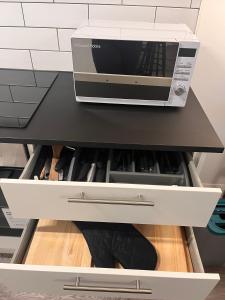 a microwave oven sitting on top of a drawer at Margate Apartment in Kent