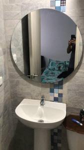 a person taking a picture of a sink in a bathroom at Apartamento completo in Tocancipá