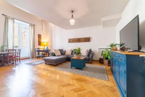 a living room with a couch and a table at Natoli Apartments in Palermo