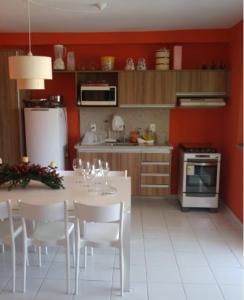 une cuisine avec une table avec des verres à vin dessus dans l'établissement GENIPABU CLUB HOUSE Guarajuba, à Camassari