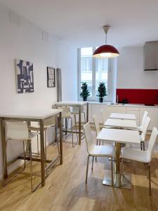 a dining room with tables and white chairs at CASA IVH BNB in Florence
