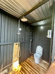 a bathroom with a toilet and a shower at Tropical eGlamping in Tân Phú