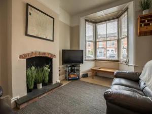 a living room with a couch and a fireplace at Pass the Keys Two bedroom Victoria Town house, easy walk of town in Shrewsbury
