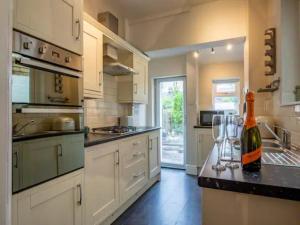 a kitchen with a bottle of wine on a counter at Pass the Keys Two bedroom Victoria Town house, easy walk of town in Shrewsbury