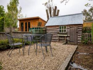 a table and chairs in front of a cabin at Pass the Keys Two bedroom Victoria Town house, easy walk of town in Shrewsbury