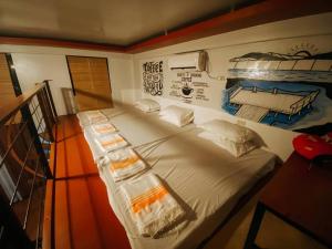 a large bed in a room with a painting on the wall at The Bistro House - Govantes Guesthouse in San Vincente +101 photos