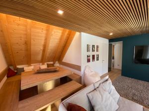 a living room with a wooden table and a couch at Luxury Chalet in the Tarvisio mountains in Camporosso in Valcanale