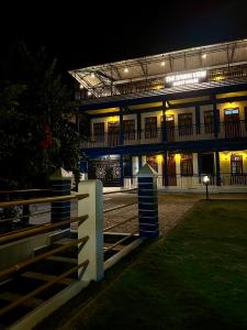a building with a fence in front of it at night at The Dawki View Guest House in Dawki