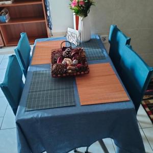 a table with a blue table cloth and blue chairs at Old House in Paradeísion
