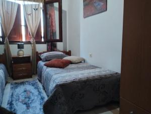 a bedroom with two beds and a window at Old House in Paradeísion