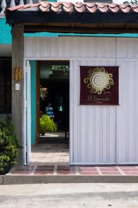 a door to a building with a sign on it at Casa El Dorado in Santa Marta