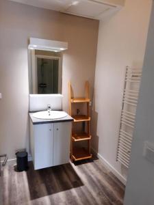 a bathroom with a sink and a mirror at Appart magnifique avec une vue exceptionnelle OLERON in La Bernerie-en-Retz