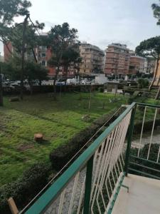 a balcony with a view of a park with buildings at Monolocale Ostia locaz.turistica in Lido di Ostia