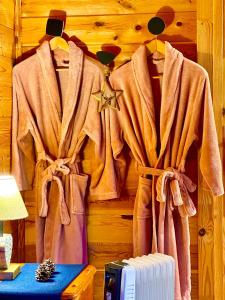 a room with coats hanging on a wall at Chalet Chevreuil avec piscine privée in Lucéram