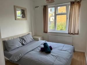 a bed with a pillow on it in a bedroom at Grundy 32 in London