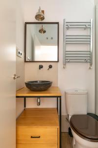 a bathroom with a sink and a toilet at PLAZA DE CASTILLA Apartments in Madrid