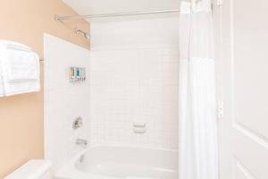 a bathroom with a shower and a tub and a toilet at 2BR Chic Executive Apartment in Prime Location in Arlington